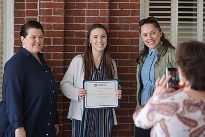 Mechanical engineering major Alana Smith, center, received a $7,500 S.E.E.D. Fund grant to develop a "food forest" in the backyard of the Centers for Women and Work on South Campus.