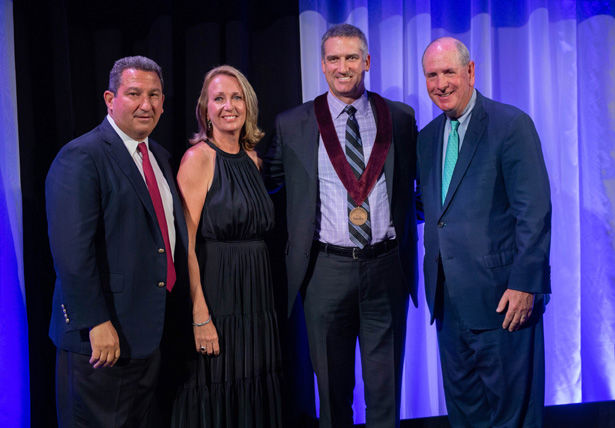 Robert and Donna Manning and Chancellor Michael F. Collins recognize Michael Stauff, MD, (center).