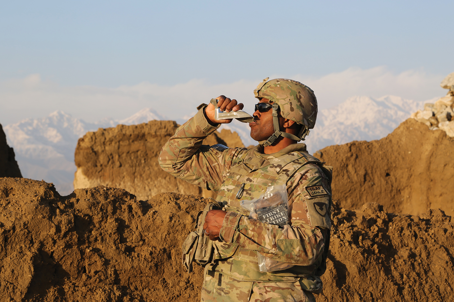 Soldier takes a drink while on duty