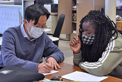  Prof. TzuYang Yu works with undergraduate civil engineering student Tiana Robinson. 