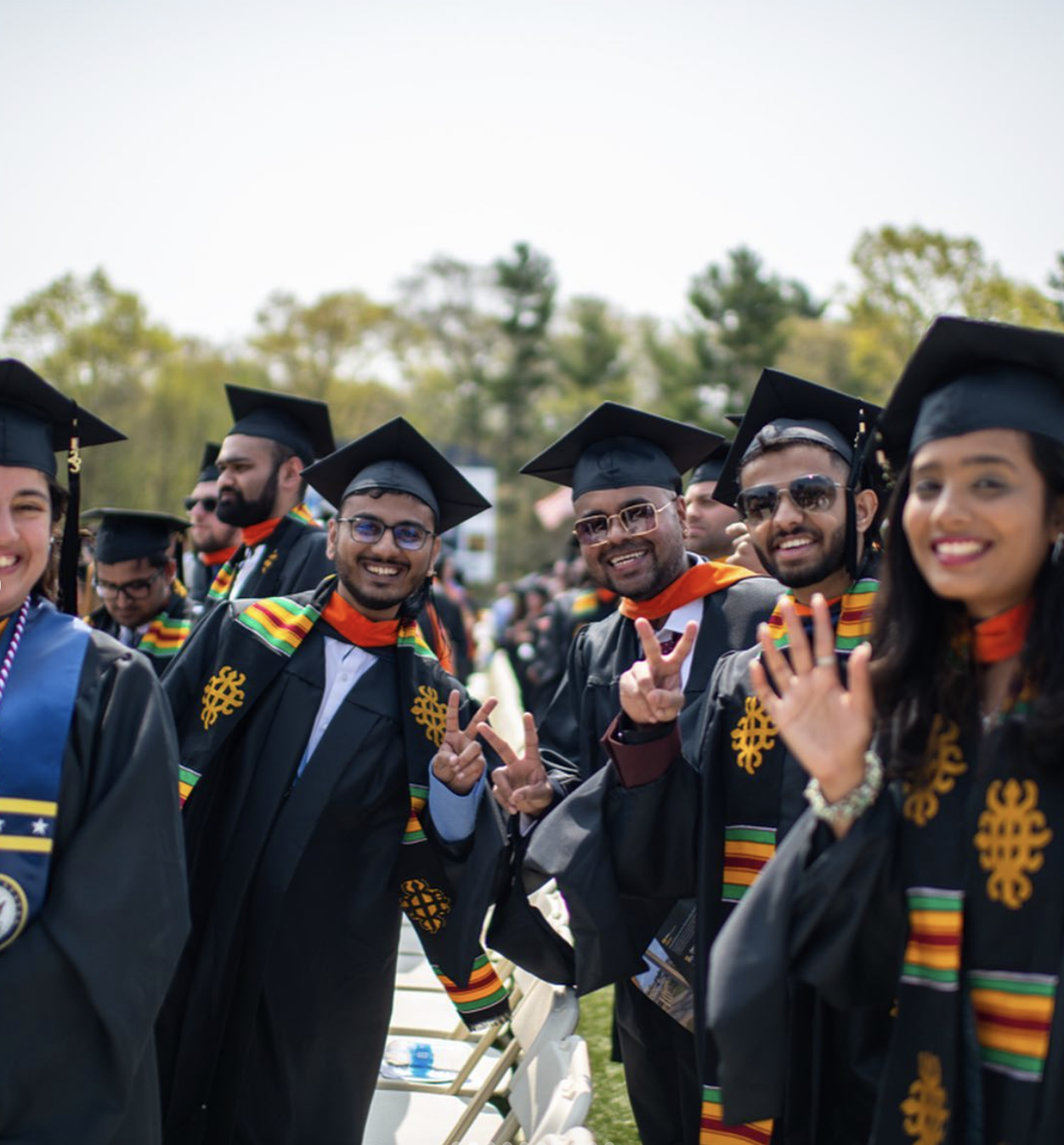2023 UMass Dartmouth graduates smiling at commencement.