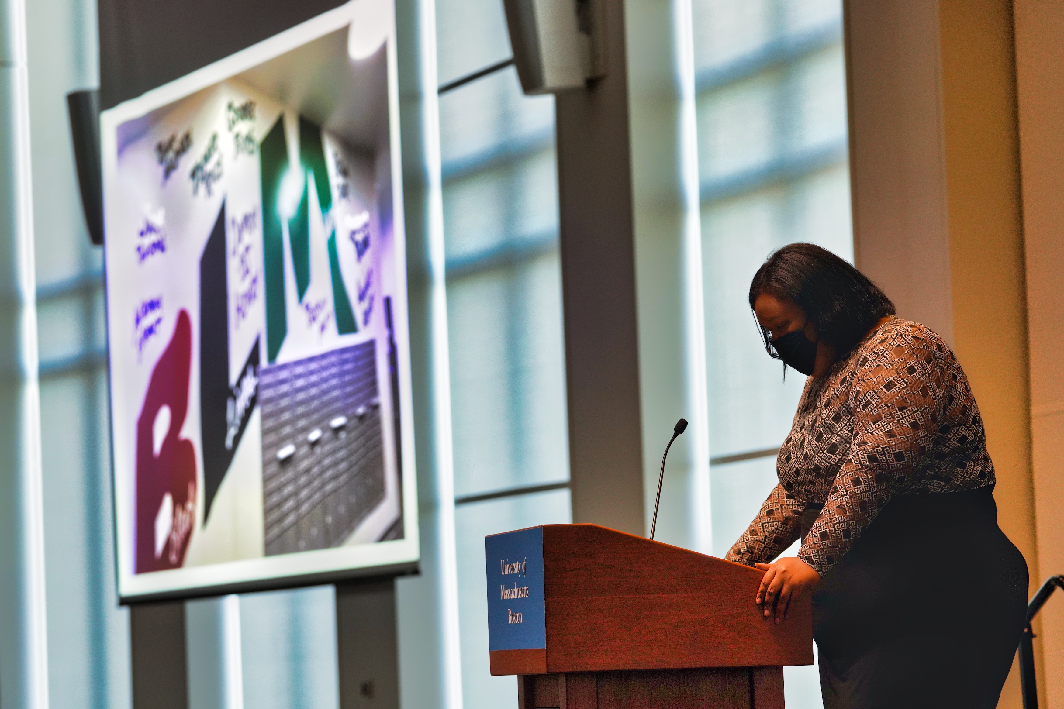 Presenting the BLM mural, Pilar Nelson bows her head in a moment of silence after reading the names added to the mural. 