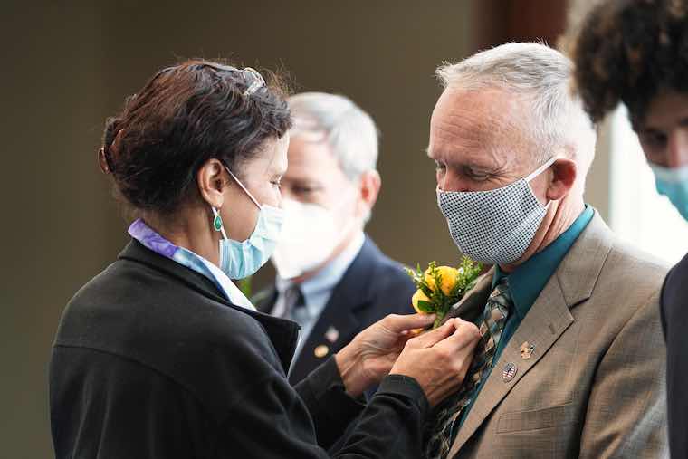 A Gold Star father receives a pin, a symbol of his family's sacrifice. Photo by Janina Seibel. 