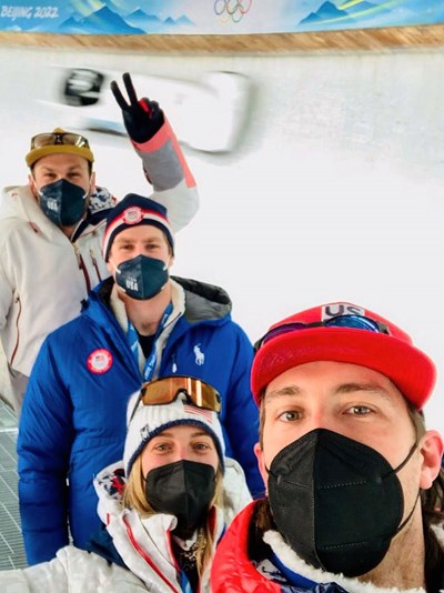 Caitlin Ciccone with three athletes on the U.S. Men's Alpine Ski Team in Beijing.