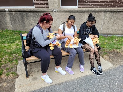 Freshmen biology majors Calie Zimmerman, Sophia Cruz and Cynthia Gomez place River Hawks shirts on stuffed animals during Spring Fest.