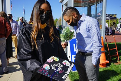 Public health graduate Melissa Antigua shows off her mortarboard.