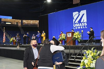 Bachelor's and master's recipients proceeded across the stage to be photographed with their diplomas, Chancellor Moloney and the dean of their college.
