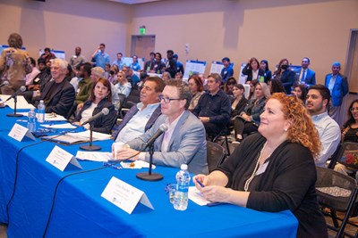 DifferenceMaker judges, from right, Lorna Boucher '86, Roger Cressey '87, Brian Rist '77, Maura Walsh '80 and Jack Wilson listen to a pitch.