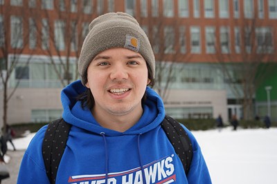 Criminal justice major Dean Poulin stands on a snowy campus