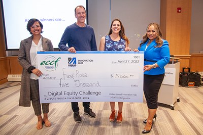 Haverhill iHub Assoc. Director Stephanie Guyotte, second from right, and EforAll's Sophan Smith, right, present a first-place check to MakeIT Haverhill's Tim Haynes.