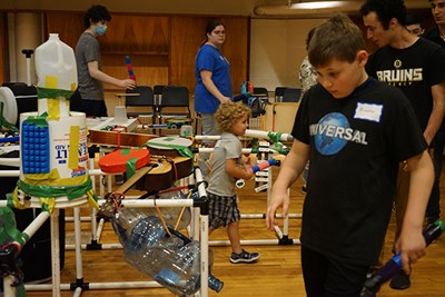 Braeden Roache, right, and his younger brother Jaymason play rhythms on the EcoSonic Playground they designed and built in Durgin Hall at a music camp for children with autism.