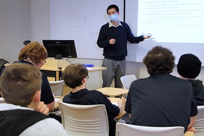 Computer Science Prof. Xinwen Fu discusses the concept of cyber penetration testing with students from Shawsheen Valley Technical High School during a recent visit to the UML Cyber Range near East Campus.