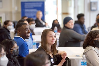 Business students and faculty listen as Honors College Dean Jenifer Whitten-Woodring explains how the mixer will work.