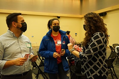 Industrial Engineering Associate Professor David Claudio, left, and Dossantos exchanged information and checked in with Honors College Assistant Director Erin Maitland at the end of the mixer.