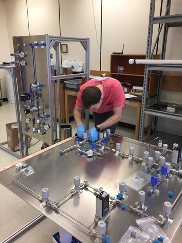 Nedlik readies the source injection panel for testing. This panel is part of the calibration system that the UMass team helped to design and build. Image credit: UMass Amherst