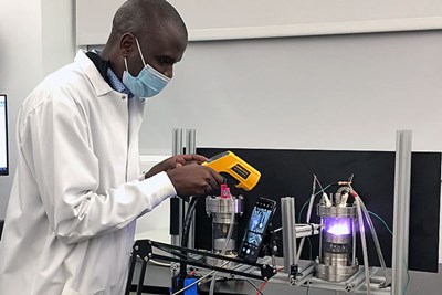 Energy Engineering doctoral student Benard Tabu works on the plasma carbonization reactor in Assoc. Prof. Juan Pablo Trelles’ Re-Engineered Energy Lab at Perry Hall on North Campus.