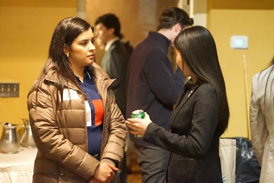 Business students Rafal Thaher, left, and Mina Lam chat during the networking event at Cobblestones.