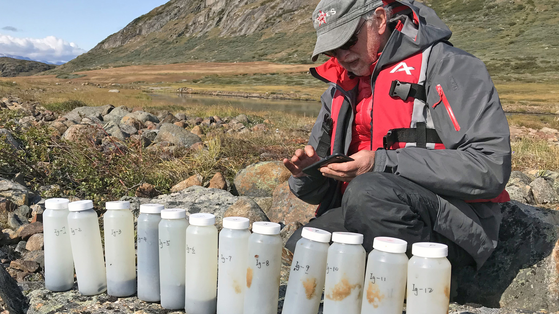 Raymond Bradley takes a photo of the sediment samples acquired from Lake Igaliku, southern Greenland.