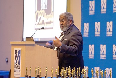 Robert Awkward, OER statewide coordinator for the Massachusetts Department of Higher Education, stands at podium during 'OERscar' Award ceremony