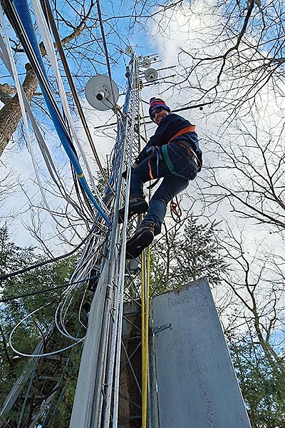 Obrist inspects the monitoring instruments mounted on the tower that measure the forest’s uptake of atmospheric mercury.