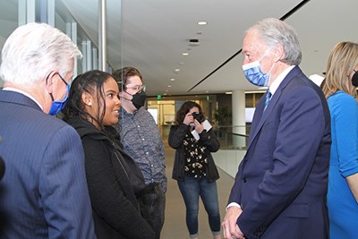 Markey talks to Vasquez as UMass President Marty Meehan listens.