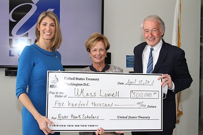 U.S. Rep. Lori Trahan, UML Chancellor Jacquie Moloney and U.S. Sen. Edward Markey hold a ceremonial check.