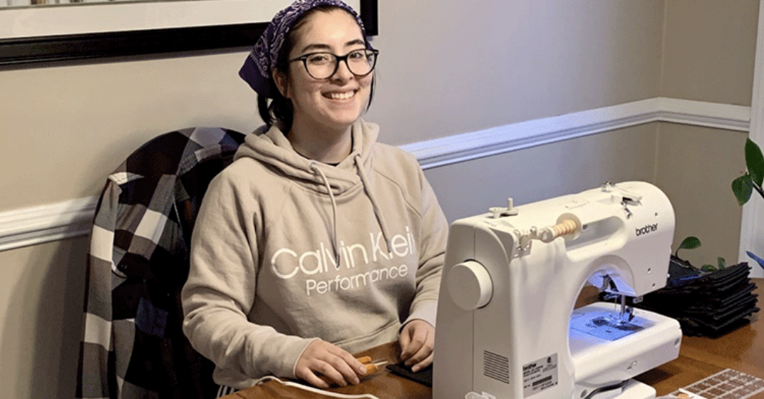 KT Taylor, '23, using one of six donated sewing machines to make PPE for local health care workers