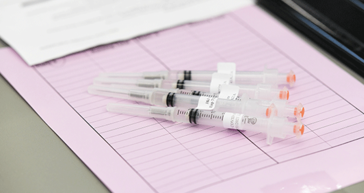 Vaccine syringes lay on table