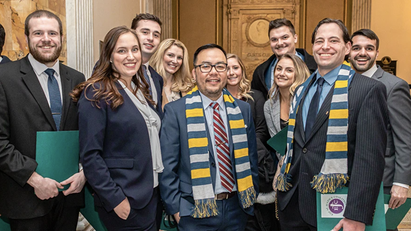 UMass Law Associate Professor Jeremiah Ho (center) with students at the 2020 Walk to the Hill at the MA State House.