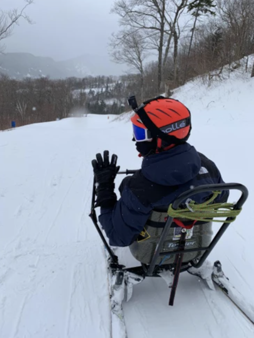 A view from behind of Revell using the joystick-controlled SnowKart