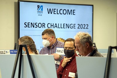 Attendees of UMass Lowell's first-annual Sensor Challenge check out poster presentations prior to the pitch competition at the Innovation Hub in Lowell.