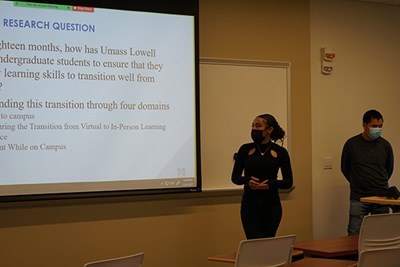 Sociology majors Sokharath Koy, left, and Taylor Billy present their research results to SGA reps and university administrators.