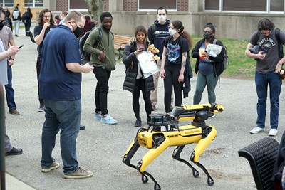 Students admire UMass Lowell NERVE Center’s Spot during Spring Fest.