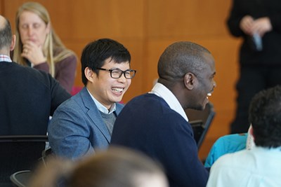 Energy engineering Ph.D. students Visal Veng, left, and Benard Tabu chat with fellow symposium attendees.