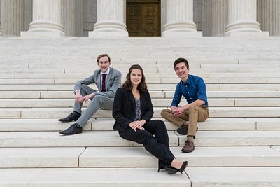 Political science majors Ben Souza and Angela DiLeo and criminal justice major Justin Bouffard sit on the Lincoln Memorial steps