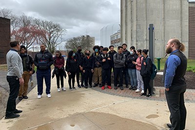 Students from Greater Lawrence Technical School listen to Physics Assoc. Prof. Andrew Rogers during a tour of North Campus led by UTeach student Matthew Sager.