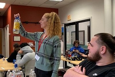 UTeach student Grace Hansen checks water samples brought in for testing by students at Greater Lowell Technical High School.