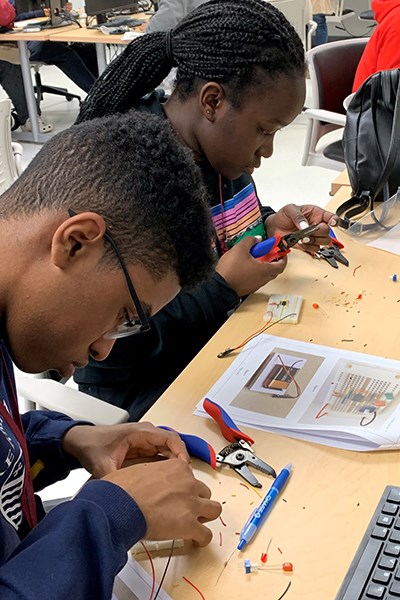 Two students from Lowell High School work on a circuitry exercise created by UTeach student Javier Palma.