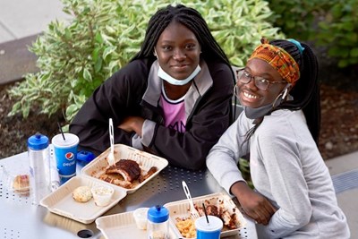 Students enjoy a barbecue dinner outside Fox Hall during one of University Dining's weekly "Street Eats" cookouts.