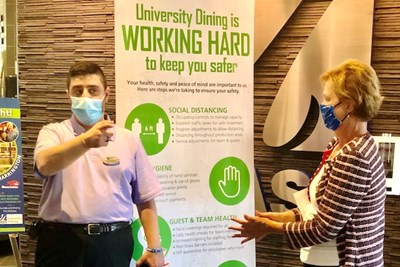 University Dining Operations Director Jirair Derkrikorian shows Chancellor Jacquie Moloney the health and safety precautions being taken at Fox Dining Commons during the pandemic.
