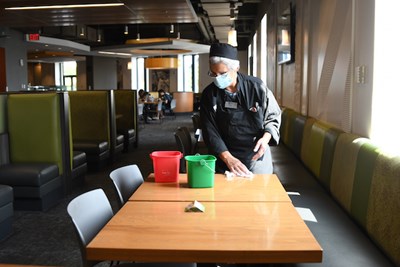 When students are finished eating, they remove a card from the table which indicates that it needs to be sanitized by a University Dining staff member.