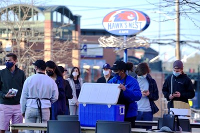 Students line up outside University Suites for panini sandwiches from After Hours, a pop-up stand run by business students in the Internship for Entrepreneurship course.