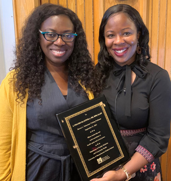 Jennifer Bradford, MD MPH (left), with guest lecturer, J. Nwando Olayiwola, MD, MPH, after presenting her with a gift of appreciation.
