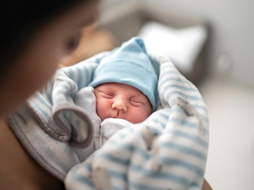 Newborn baby held by mom