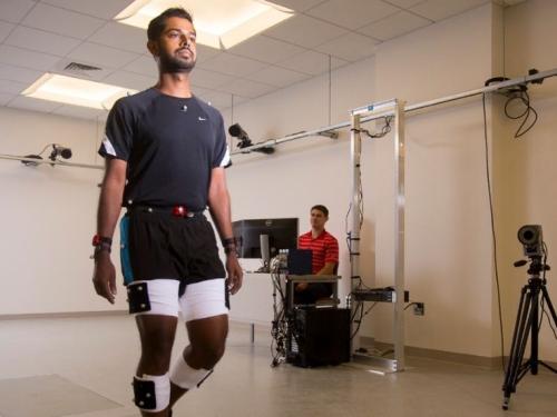 Two students work on an experiment in the Human Motion facility at UMass Amherst