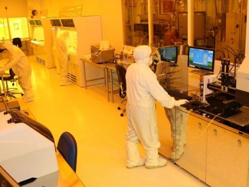 Two researchers in Hazmat suits work in the Nanofabrication Class 100 Clean Room at UMass Lowell.