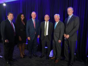 L-R: UMass Board of Trustees Chair Rob Manning, UMass Chan Medical School graduate and UMass Trustee Dr. Chioma Okwara, UMass Chan Medical School Chancellor Dr. Michael Collins, Dr. Gerald Chan, UMass President Marty Meehan, and Gov. Charlie Baker
