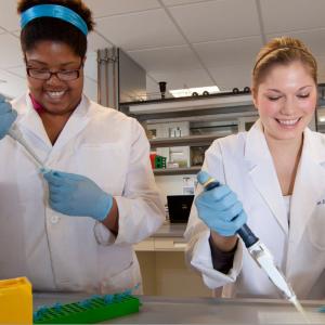 Two UMass students in a lab conducting medical research.