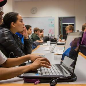 Students with laptops in a classroom