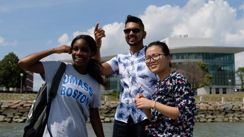 Three smiling UMass Boston students